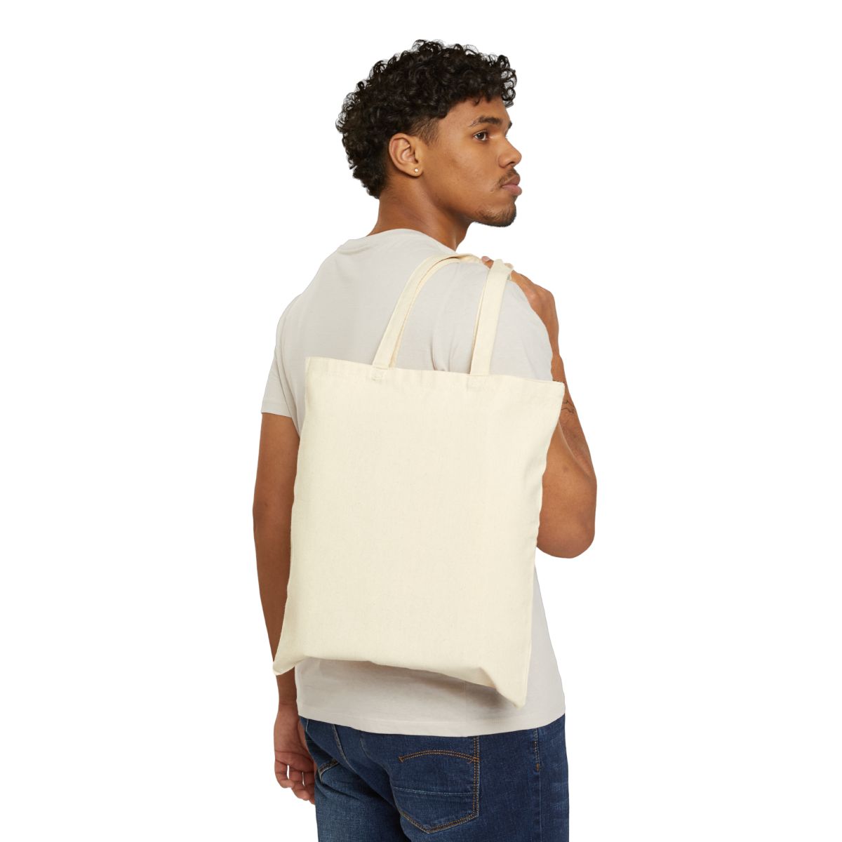 Library Haul No Regrets Canvas Tote — Natural 15 × 16 inch cotton canvas tote, supplier worn mockup, plain reverse